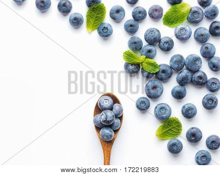 Blueberries isolated on white background. Blueberry border design. Ripe and juicy fresh picked bilberries close up. Copyspace. Top view or flat lay