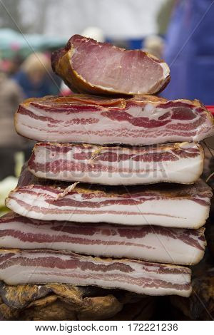 Home made smoked bacon and smoked meat in a street marketselective focus and small depth of field