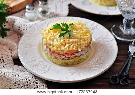 Salad of boiled potatoes, carrots, eggs, hard cheese, smoked chicken breast and white onion with mayonnaise. Russian traditional festive salad.
