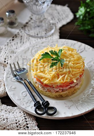 Salad of boiled potatoes, carrots, eggs, hard cheese, smoked chicken breast and white onion with mayonnaise. Russian traditional festive salad.