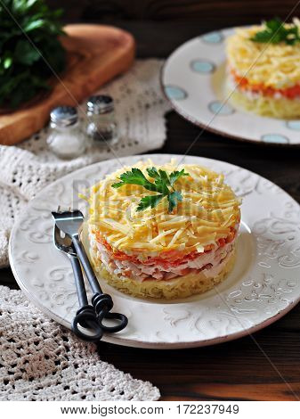 Salad of boiled potatoes, carrots, eggs, hard cheese, smoked chicken breast and white onion with mayonnaise. Russian traditional festive salad.