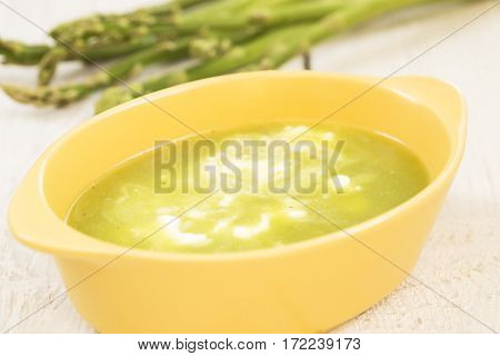 Asparagus soup in a yellow ceramic dish