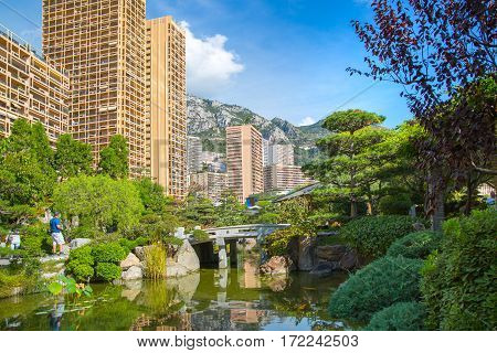 Monaco, Monte Carlo - September 17, 2016:  Jardin Japonais, Japanese Garden view with residential buildings at the background.