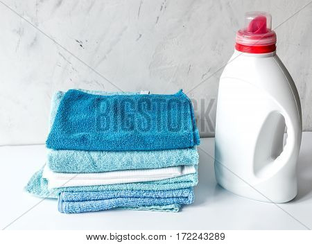 blue towels pile in housekeeping set on laudry gray background mock up