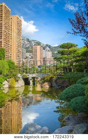 Monaco, Monte Carlo - September 17, 2016:  Jardin Japonais, Japanese Garden view with residential buildings at the background.
