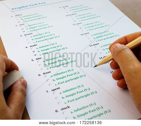 multiple choice english exam on table with hand