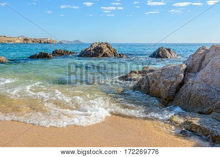 Playa el Chileno Beach, Cabo San Lucas, Mexico. Different stages of the fantastic ocean waves. Rocky and sandy beach.
