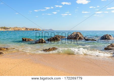 Playa el Chileno Beach, Cabo San Lucas, Mexico. Different stages of the fantastic ocean waves. Rocky and sandy beach.
