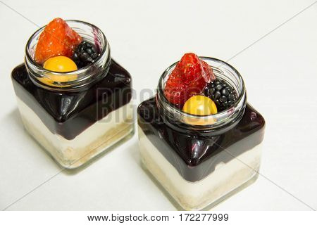 A Blueberry filling and creamcheese served in glass