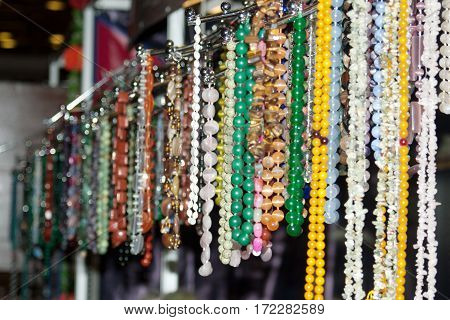 The counter with colorful beads and necklaces