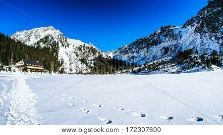 Snowy frozen lake Popradske pleso in winter High Tatras mountains Slovakia