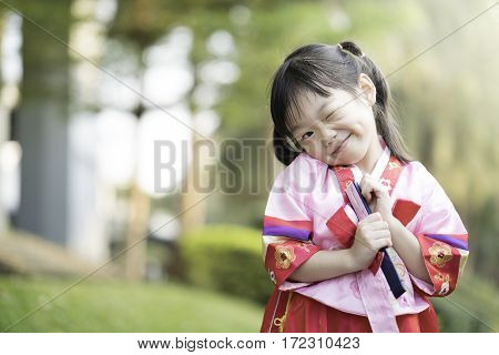 Korean child wearing a Traditional Hanbok in the park
