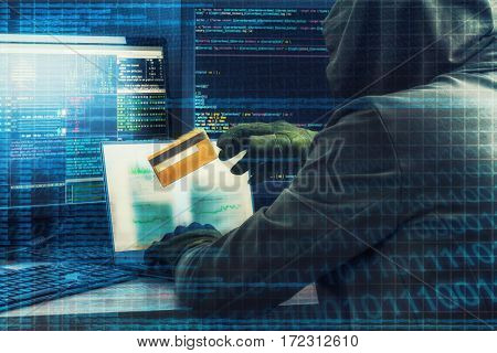Internet concept. Hacker working on a code on dark digital background with digital interface around.