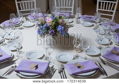 wedding flower arrangement with blue violet pink flowers