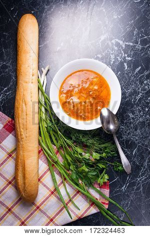 Vegetables And Meat In Red Beetroot Soup Or Borsch In White Plate On Dark Marble Background.