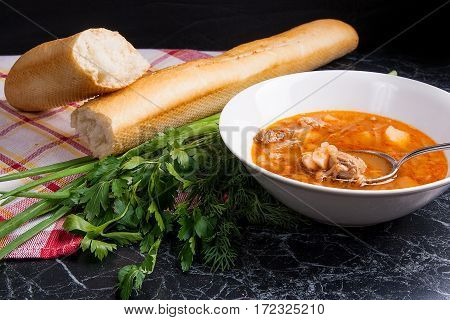 Vegetables And Meat In Red Beetroot Soup Or Borsch In White Plate With Metal Spoon In It On Dark Mar