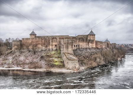 Ivangorod, Russia - January 2, 2017: View of Ivangorod Fortress museum on Russian territory from Estonian territory. Foreground is Narva (Narova) River, which is international border between two countries