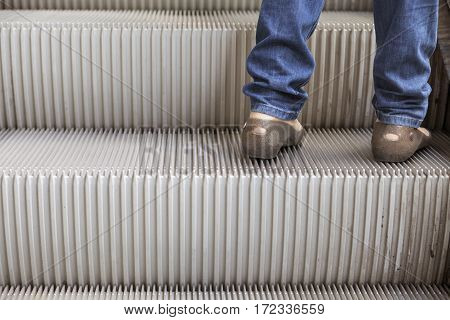 Young women step on escalator with copy space