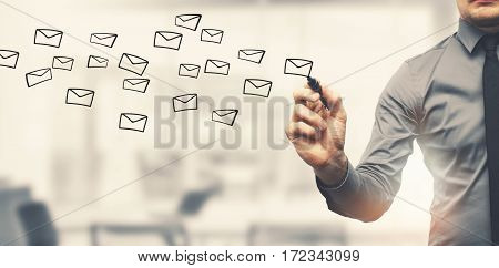 sending email concept - businessman drawing envelopes in offiice