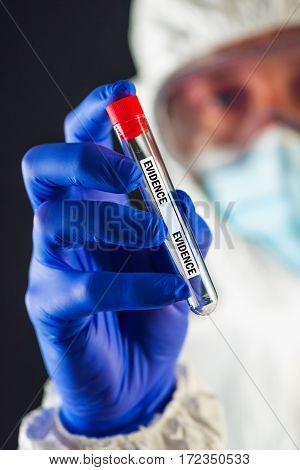 Forensic scientist with evidence tube during crime scene investigation