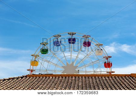 Brown roof ferris wheel and blue sky day view