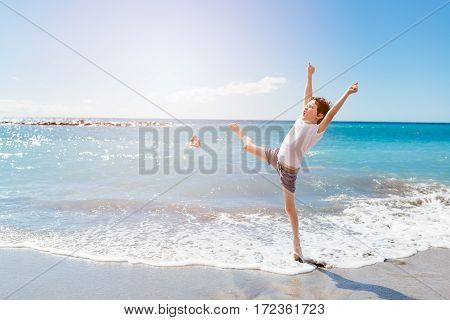 Happy 7 Years Boy Jumping On The Beach