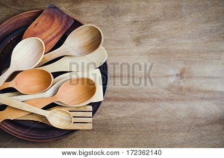Rustic Kitchen Utensils: the Ceramic Plates and Wooden Cutlery on Wooden Background. Home Wares. Kitchen Decor in Rustic Style. View From Above With Copy Space.
