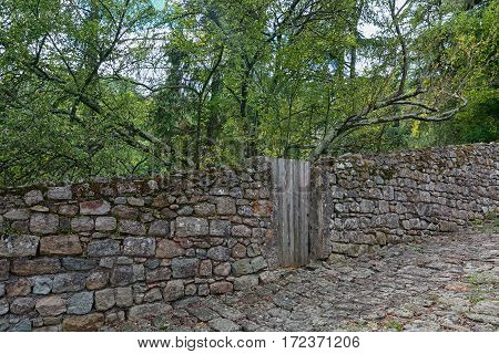 Old stone wall and door in the town of Largentiere in the Ardeche region of France