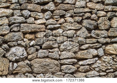 Part of an old stone wall with clay masonry