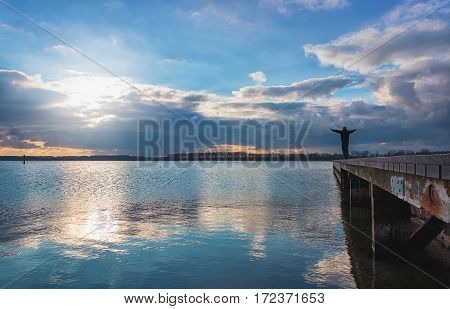 Man enjoys the spectacular sky over Lake Veere in the Zeeland province of the Netherlands