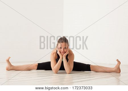 Girl In Black Clothes Doing Yoga. Upavishta Konasana. Inscription On Pendant