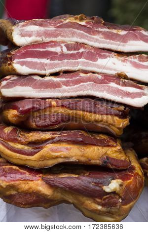 Home made smoked bacon in a street market selective focus and small depth of field