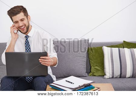 Smiling Young Telecommuter With Laptop