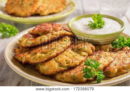 Vegetable fritters with potato, carrot and zucchini served with Ranch sauce.