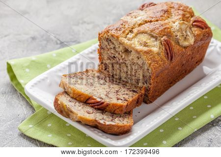 Sliced banana bread with a pecan nuts