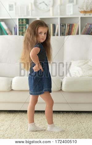 adirable little girl with beautiful long hair at home