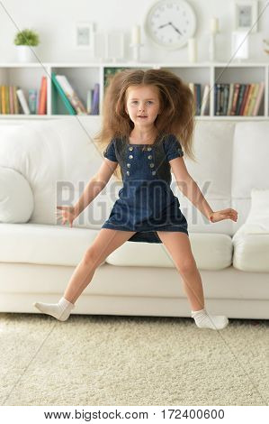 adirable little girl with beautiful long hair at home