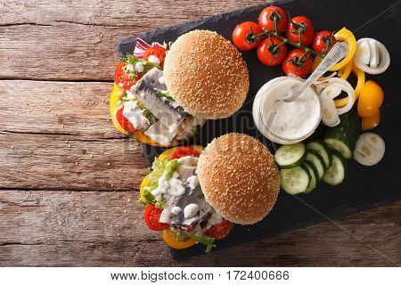 Fishburger With Herring, Gravy And Fresh Vegetables Close-up. Horizontal Top View