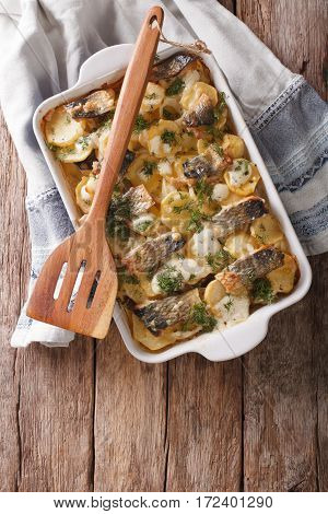 Finnish Food: Casserole With Potatoes And Herring Close Up In Baking Dish. Vertical Top View