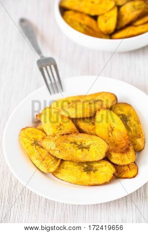 Fried slices of ripe plantains a traditional and popular snack and accompaniment in Central America and Northern South America photographed with natural light (Selective Focus Focus one third into the image)