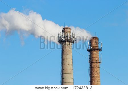 Smoke from pipe on a background of clear sky