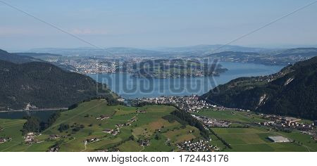 Lake Vierwaldstattersee Lucerne and green farmland. View from mount Stanserhorn.