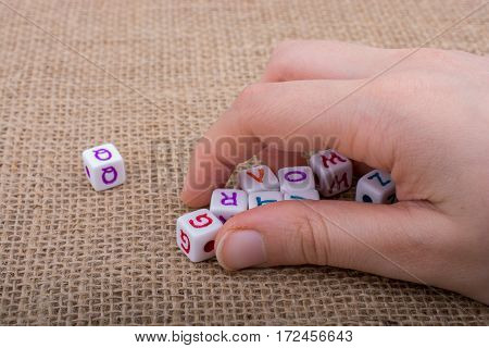 Colorful Alphabet Letter Cubes In Hand
