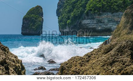 Rock in Tembeling Coastline at Nusa Penida island, Ocean Waves in Front. Bali Indonesia.