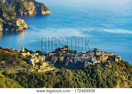 Corniglia village and Manarola in background at sunset. Seascape in Five lands Cinque Terre National Park Liguria Italy Europe.
