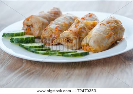 stuffed cabbage is a traditional Ukrainian meals stewed cabbage leaves stuffed with ground meat and rice with sour cream with sliced cucumbers
