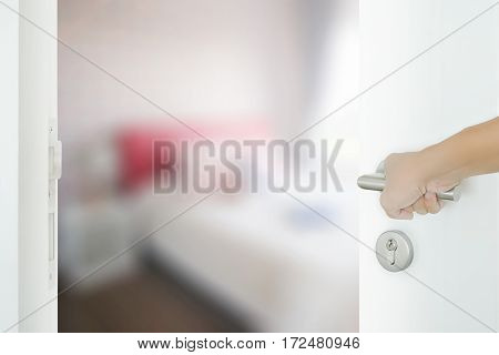 man hand opening white door to bedroom in modern intrior style