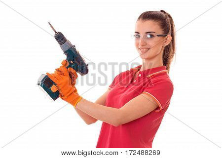 young girl in goggles holding a drill is isolated on a white