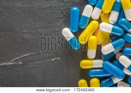Pile Of Medical Pills And Blue Pills On A Background