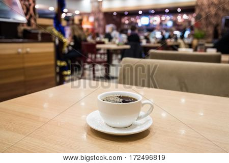 Teapot and cups are prepared for tea drinking in cafe